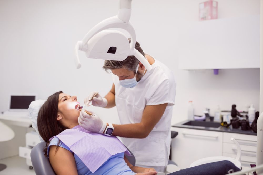 a lady is getting genral dentistry treatment for a good oral health